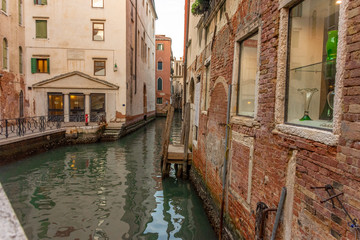 Fototapeta na wymiar Italy, Venice, view of a canal between the buildings.