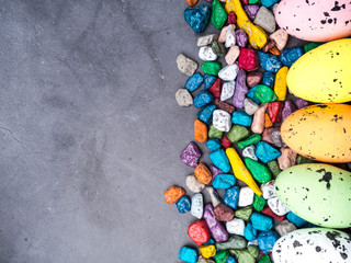 Colorful Easter Egg, sweet candies background. Top view with copy space