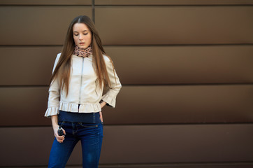 Vape teenager. Young pretty white girl in casual clothing smoking an electronic cigarette opposite...