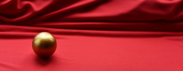 Easter egg hand painted gold on a red background