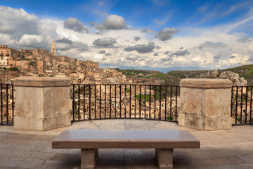 Panoramic view of the ancient town of Matera (Sassi di Matera), European Capital of Culture 2019. Belvedere with blue sky and clouds, Basilicata, southern Italy. - obrazy, fototapety, plakaty