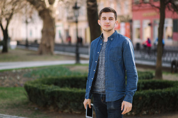 Young man listening a music through wireless headphones