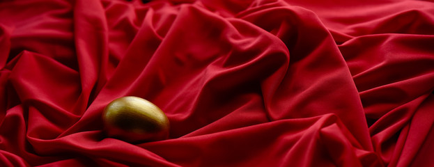 Easter egg hand painted gold on a red background