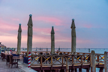 Italy, Venice, view of an outdoor bar at sunset