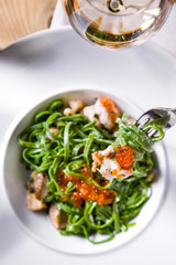 Pasta with shrimp and salmon caviar.