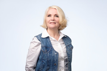 Smiling senior european blonde woman looking at camera.