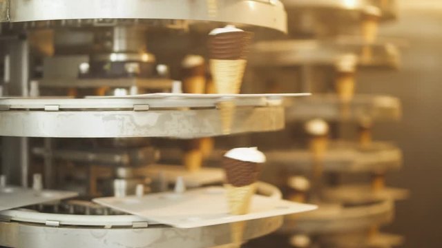 ice cream production, transportation waffle-cone with plombir ice cream on production line, dairy products.