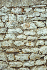 Texture of old stone wall. Surface from grey rocks, built witout cement. Vertical background
