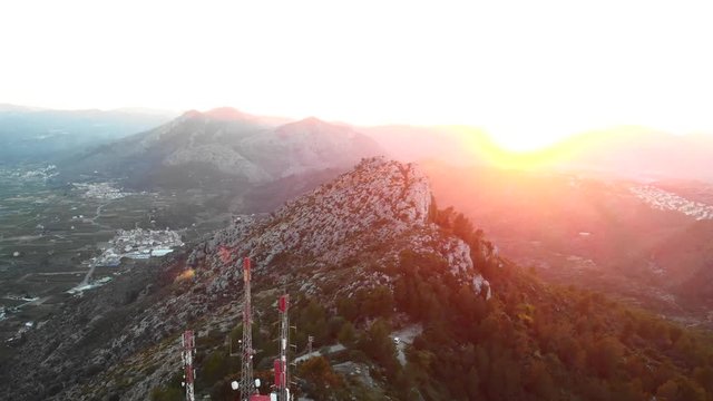 Aerial drone view of telecommunication antennas at sunset, in Segaria mountain, in Marina Alta, Alicante, Spain