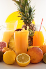 Fresh juice dynamic splash. A glass of fruit drink and fruits on a white background. Delicious, tasty, sweet summer set. 