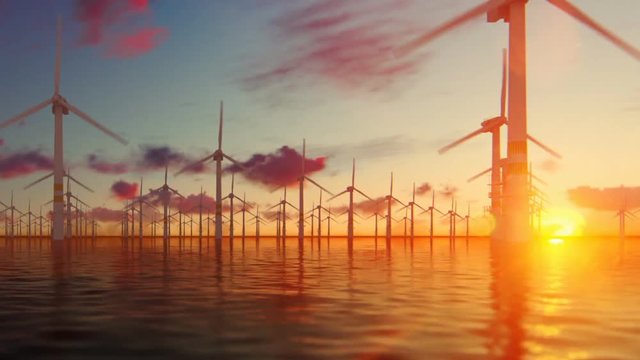 Offshore windmills with technician boat at sunset, panning
