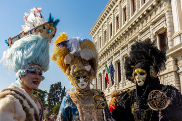 Venice, carnival 2019, typical masks, beautiful clothes, posing for photographers and tourists.
