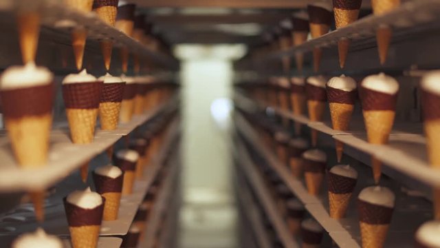 ice cream production, transportation waffle-cone with plombir ice cream on production line, dairy products.