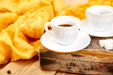 Two cups of coffee espresso near sugar cube