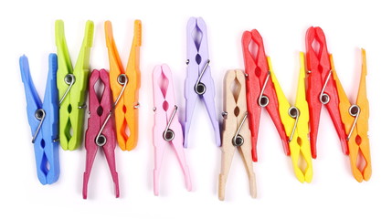 Colorful plastic clothespins isolated on white background, top view