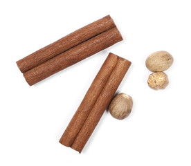 Cinnamon sticks and nutmegs isolated on white background, top view