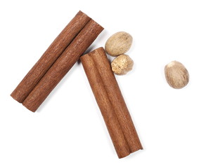Cinnamon sticks and nutmegs isolated on white background, top view