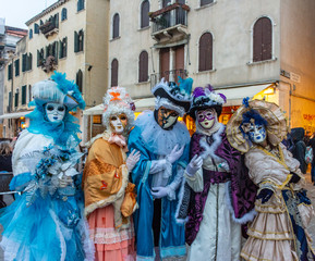 Fototapeta na wymiar Venice, carnival 2019, typical masks, beautiful clothes, posing for photographers and tourists.