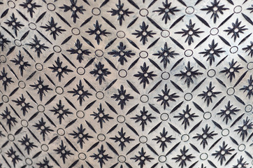 tile with abstract geometric white pattern