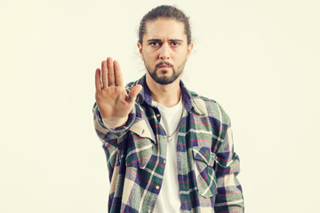 Stop - concept. Close up portrait of a young man shows hands a gesture of denial, refusal, on light background.