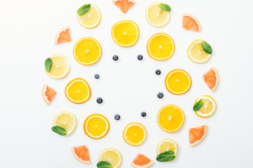 Flat lay with cut fruits and blueberries on white surface