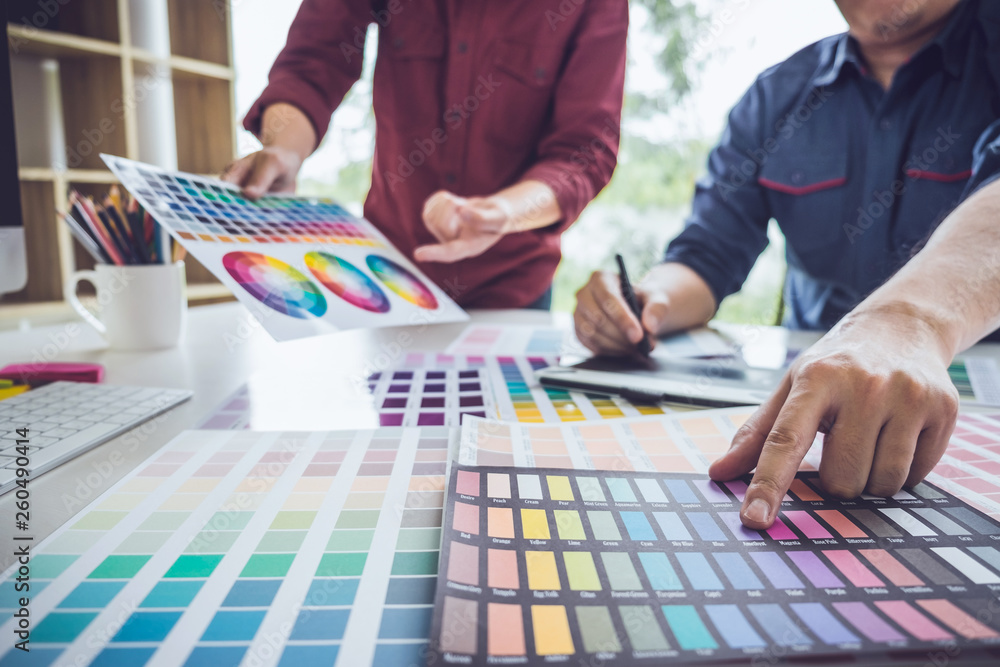 Poster two colleague creative graphic designer working on color selection and color swatches, drawing on gr