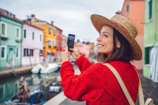 Smiling tourist takes photos in Italy