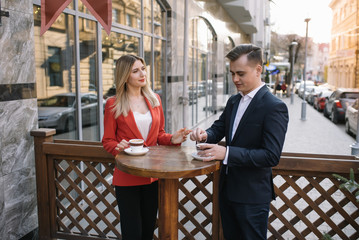 Young couple of professionals chatting during a coffee break