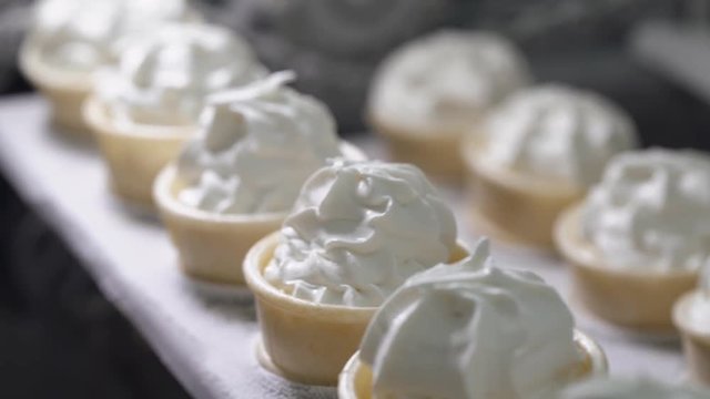 ice cream production, transportation waffle-cone with plombir ice cream on production line, dairy products.