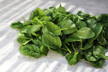 Baby spinach, fresh green leaves on the kitchen counter.