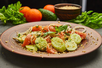 Fresh spring detox mix salad with vegetables such as tomatoes, cucumbers and onion