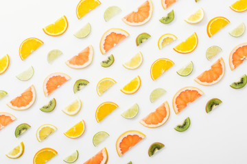 Flat lay with juicy cut fruits on white surface