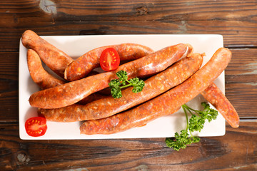 raw sausage on wooden board