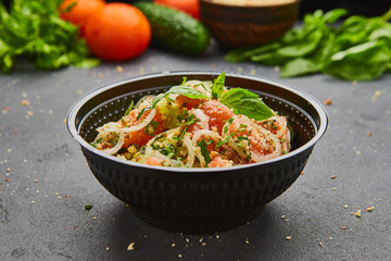 Fresh spring detox mix salad with vegetables such as tomatoes, cucumbers and onion