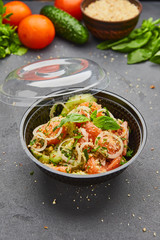 Fresh spring detox mix salad with vegetables such as tomatoes, cucumbers and onion