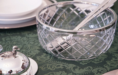 Tableware in a glass container on the table