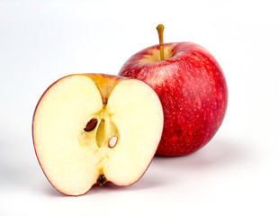 red apple with apple half on white background, new zealand queen apple
