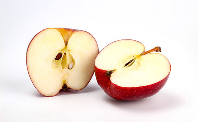 red apple with apple half on white background, new zealand queen apple