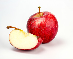 red apple with apple half on white background, new zealand queen apple