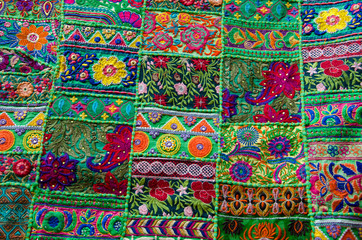 Colorful hand stitched blankets displayed on the wall, situated in the fort complex, Jaisalmer, Rajasthan, India.