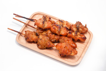 Chicken butt grilled on wooden plate isolated on white background, traditional street food in thailand