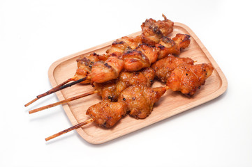 Chicken butt grilled on wooden plate isolated on white background, traditional street food in thailand