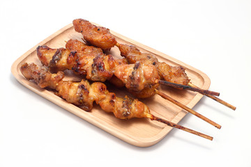 Chicken butt grilled on wooden plate isolated on white background. Street food in thailand