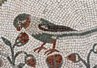Detail of ancient colorful mosaic showing a bird