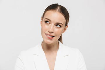 Beautiful happy woman posing isolated over white wall background.