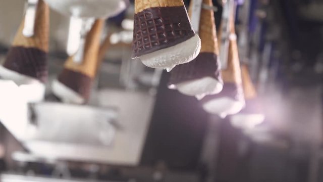 ice cream production, transportation waffle-cone with plombir ice cream on production line, dairy products.