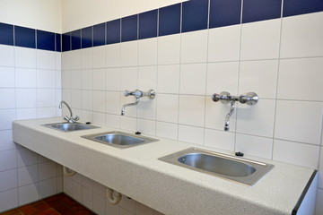 Fototapeta na wymiar Modern utility room of a campsite. Stainless steel sinks in the utility room of a campsite in Schleswig Holstein, Germany, Europa