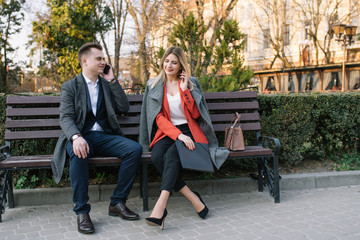 Happy Business Man and Woman Chatting on Bench