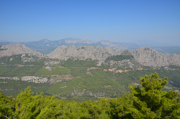Fototapeta na wymiar Panorama of the Taurus Mountains on the background of a summer blue sky on a sunny day near Antalya, Turkey
