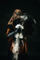 Portrait of a shaman holding a steaming horn